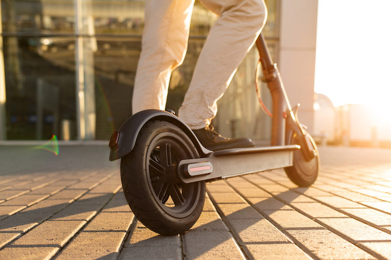 Man on Electric Scooter during the Day.