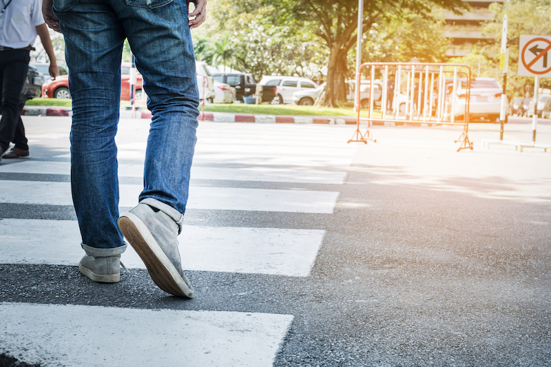 Person walking across crosswalk