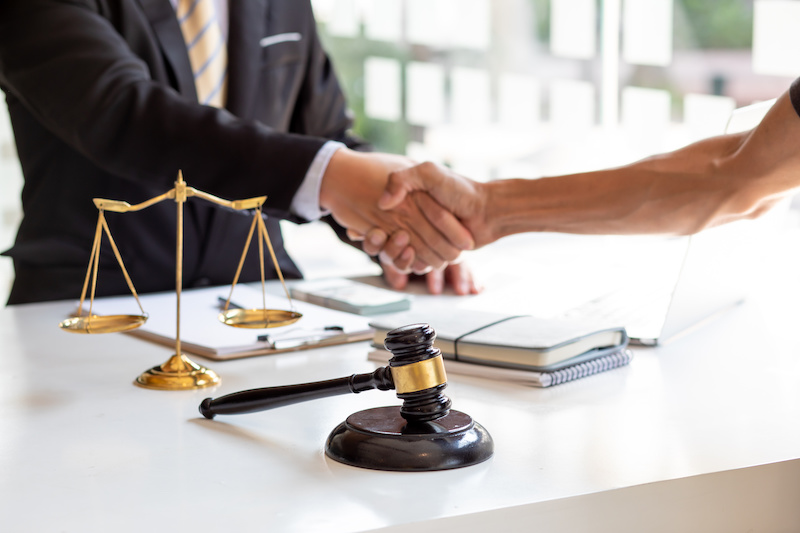 Lawyer shaking hands with client