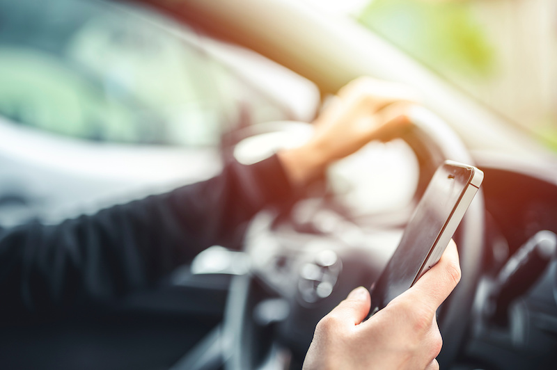 Driver looking at cell phone while on the road